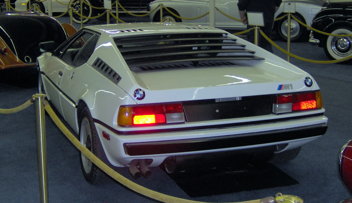 1981 BMW M1 street car, rear three-quarter in red at a collection display