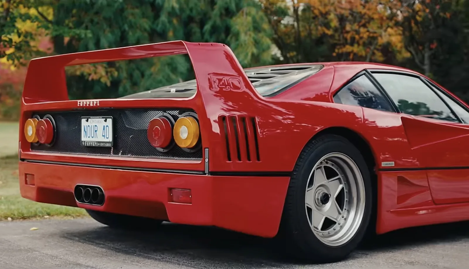 Ferrari F40 rear detail with the fixed rear wing, F40 script, twin round taillights and triple centre exhausts