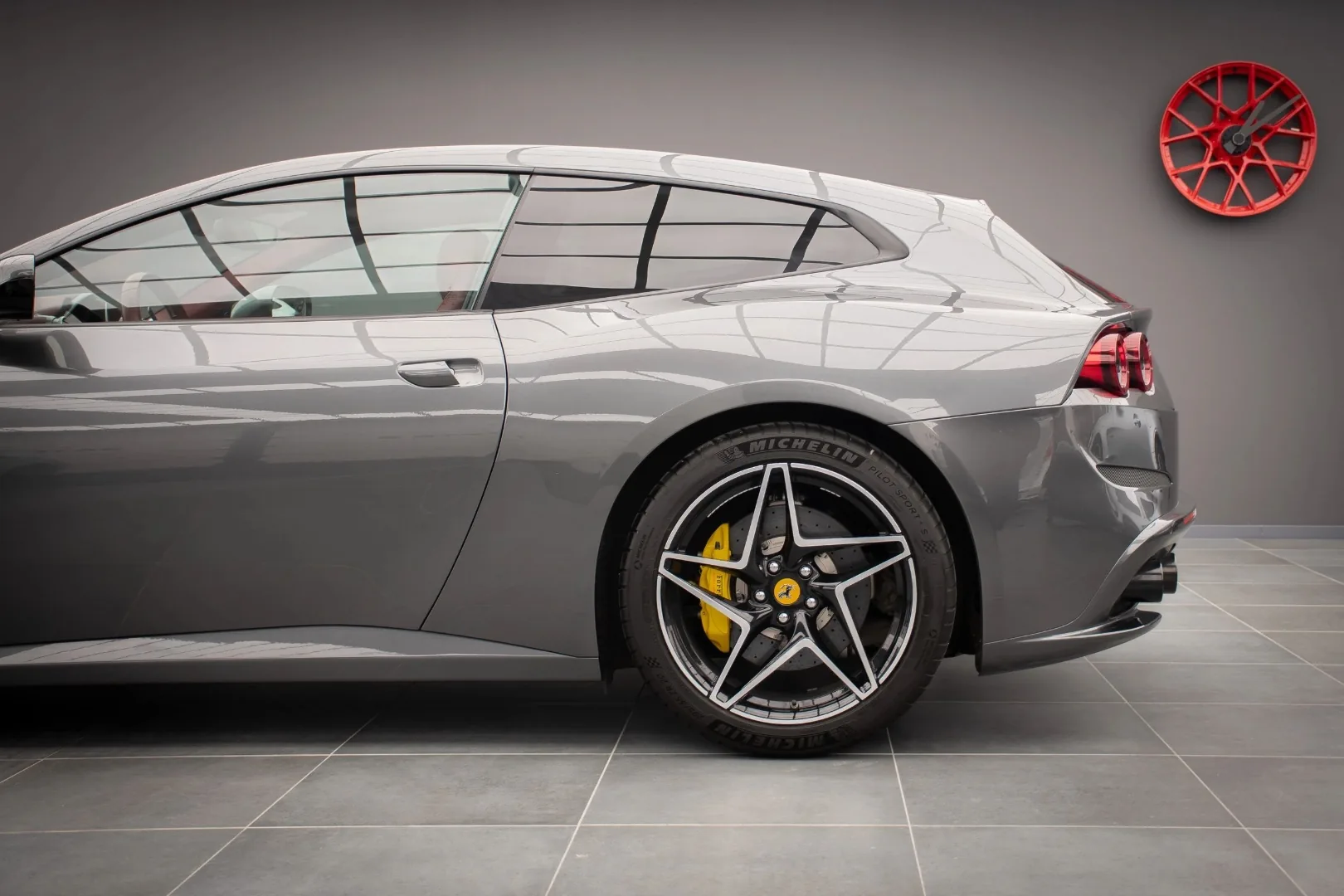 Ferrari GTC4 Lusso V12 rear quarter view with yellow brake caliper and Michelin tire