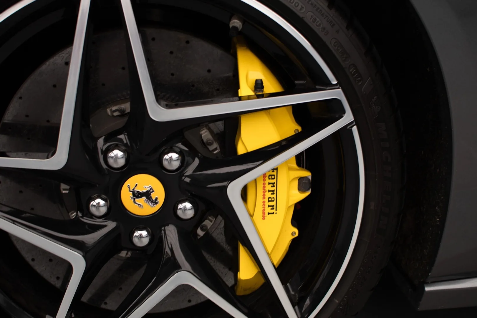 Ferrari GTC4 Lusso V12 wheel detail with carbon ceramic brakes and yellow caliper