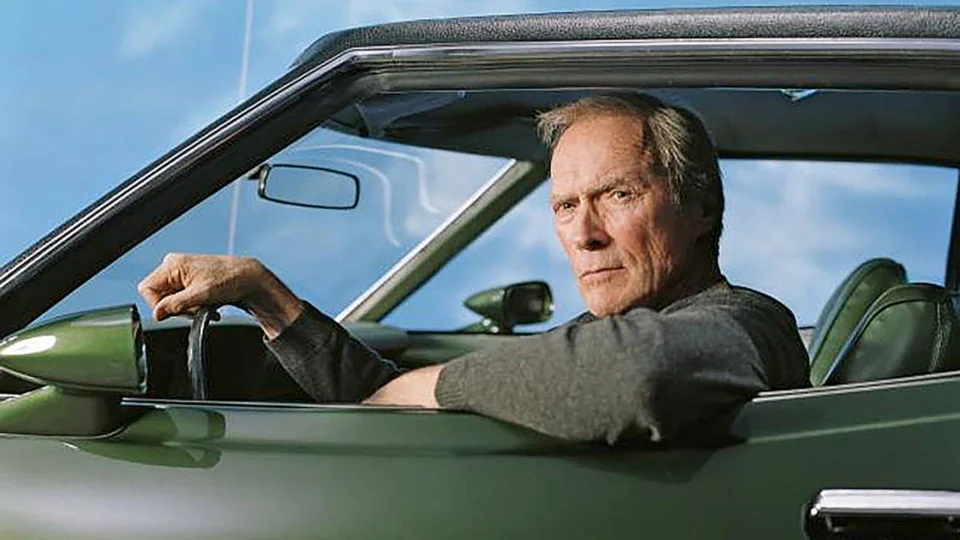Clint Eastwood as Walt Kowalski at the wheel of the dark green 1972 Ford Gran Torino Sport in Gran Torino