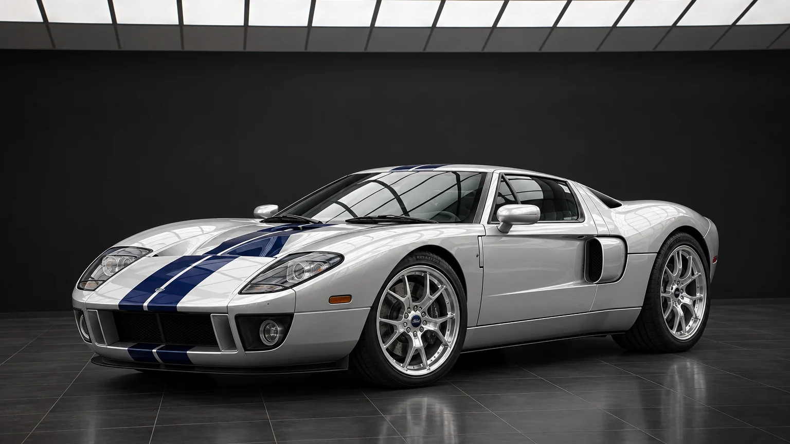 2005 Ford GT in silver with blue racing stripes, studio front three-quarter