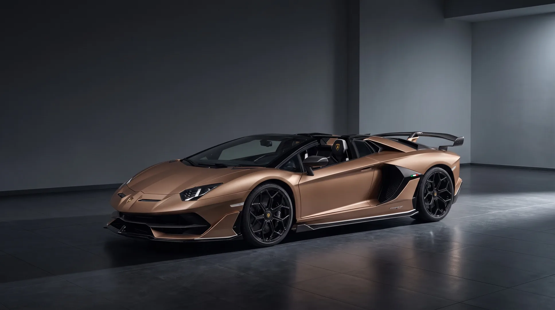 Lamborghini Aventador SVJ Roadster in matte bronze, front three-quarter studio view with the roof panels removed