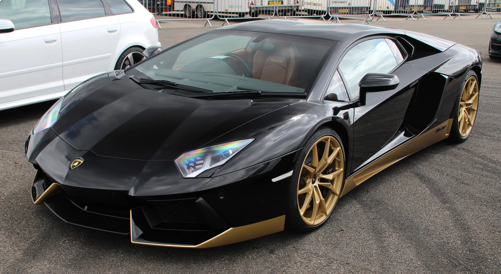 Lamborghini Aventador Miura Homage in black with gold sills and gold wheels, front three-quarter view