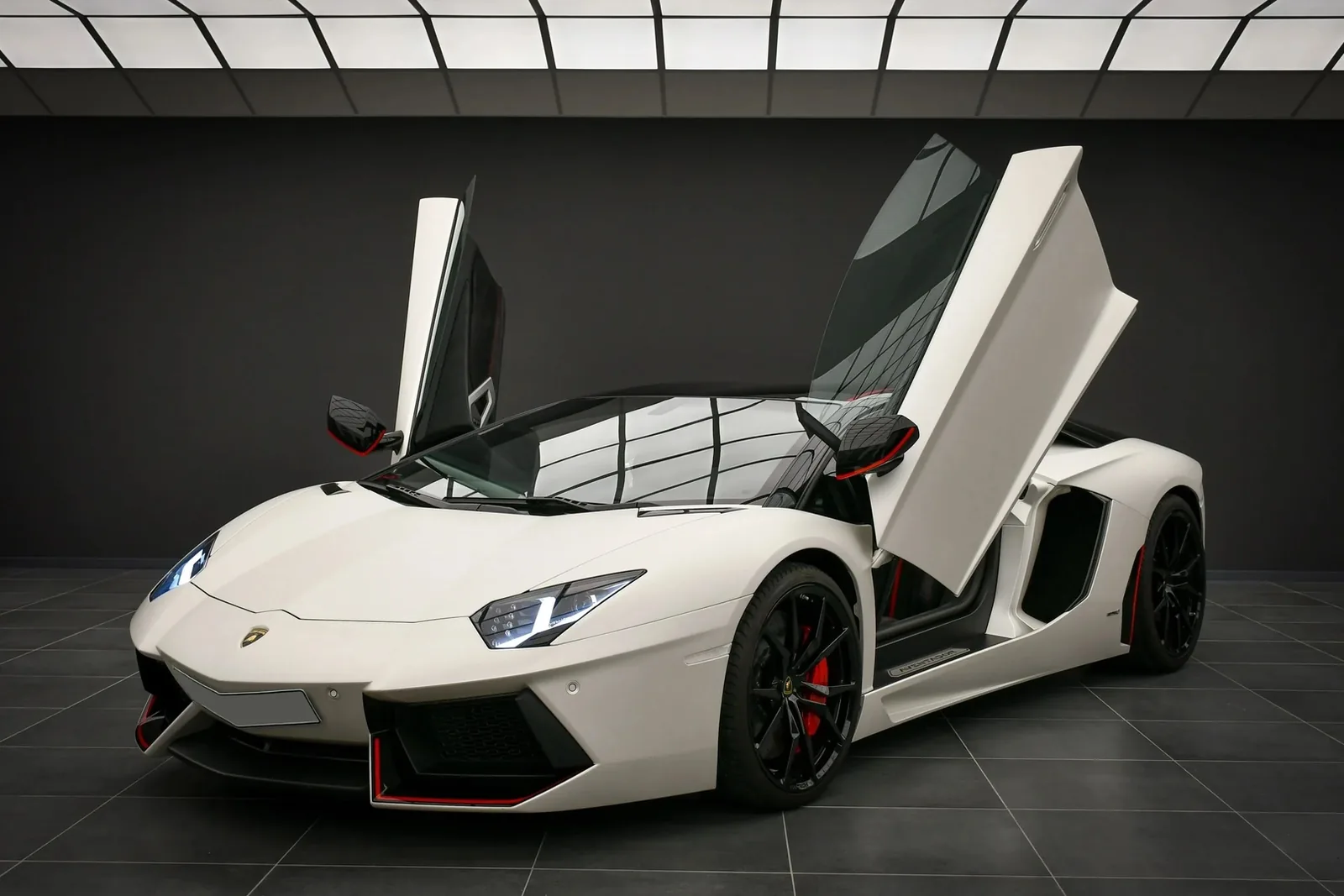 Lamborghini Aventador LP 700-4 Pirelli Edition Roadster in white with red accents and the scissor doors raised