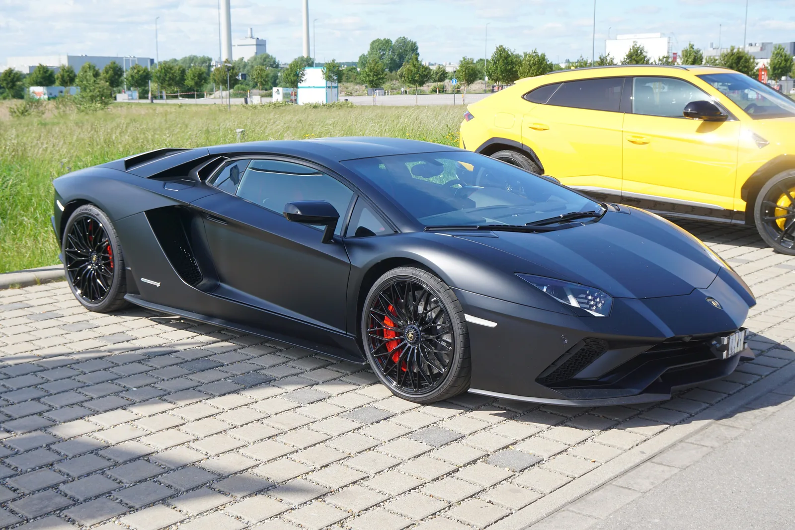 Lamborghini Aventador S side profile in matte dark grey showing the reprofiled front bumper and new side sills