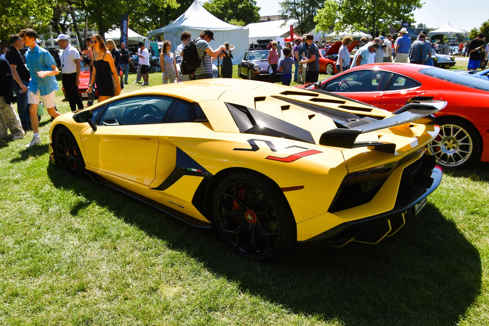 Lamborghini Aventador SVJ in yellow, rear three-quarter side view showing the ALA 2.0 rear wing and Superveloce Jota decals