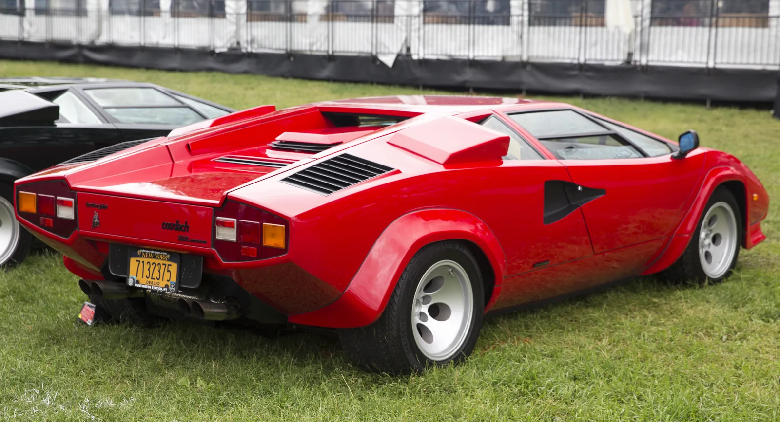Rosso Lamborghini Countach 5000 Quattrovalvole rear three-quarter showing hexagonal tail lamps, slatted engine cover and wide arched haunches