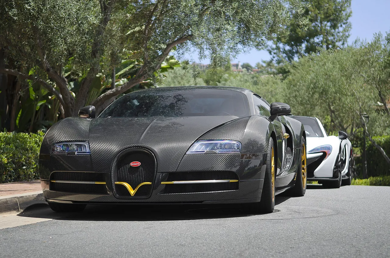 Matte black Bugatti Veyron Mansory Linea Vincero with gold details, parked outdoors