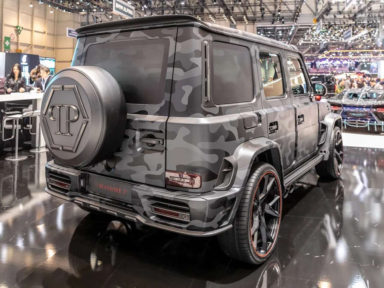 Grey camouflage Mansory Star Trooper G-Class with Philipp Plein spare wheel cover at the 2019 Geneva Motor Show, rear three-quarter view