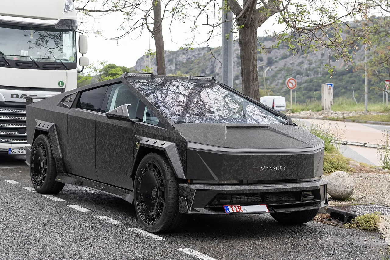 Dark grey Tesla Cybertruck with Mansory Elongation Evo kit and large forged wheels, front three-quarter view