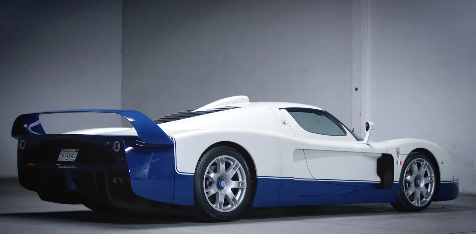Maserati MC12 Stradale rear three-quarter view with the towering blue rear wing, rear diffuser and centre exhausts