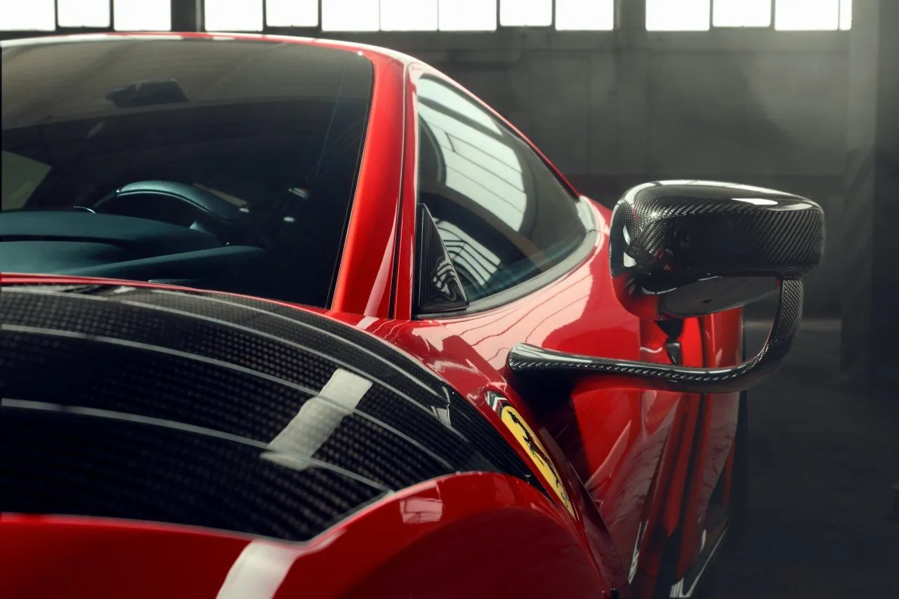 Close-up of a red Novitec Ferrari F8 N-Largo carbon mirror and carbon engine cover
