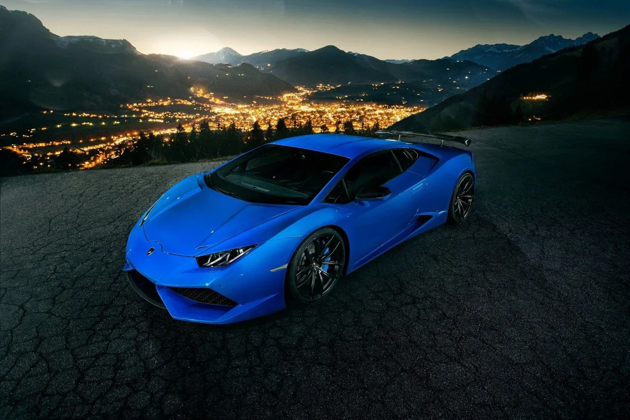 Blue Novitec Torado Lamborghini Huracan N-Largo on a mountain road at night above city lights