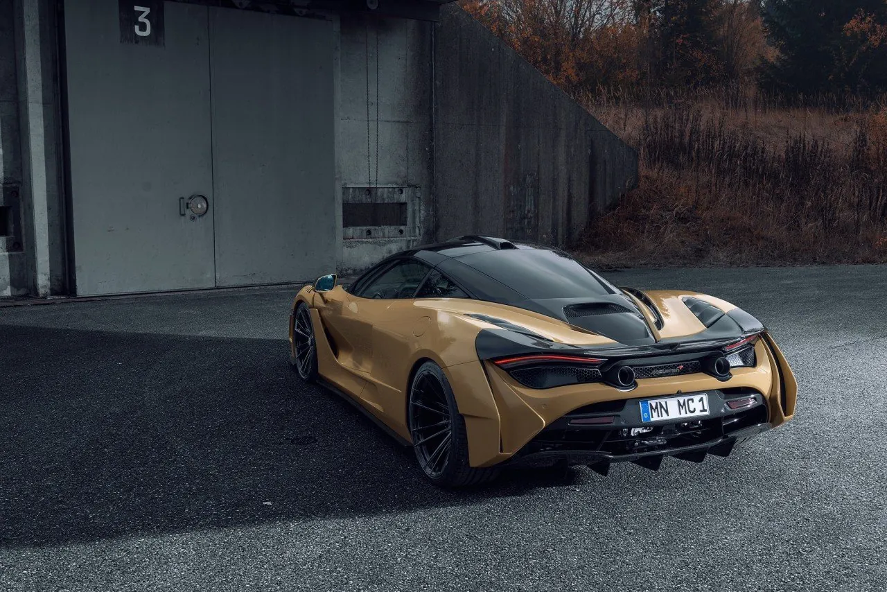 Gold Novitec McLaren 720S N-Largo rear three-quarter view in front of a concrete bunker