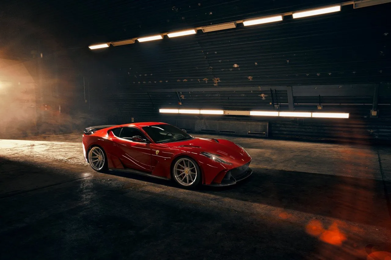 Red Novitec Ferrari 812 N-Largo widebody in a dark hangar, front three-quarter view