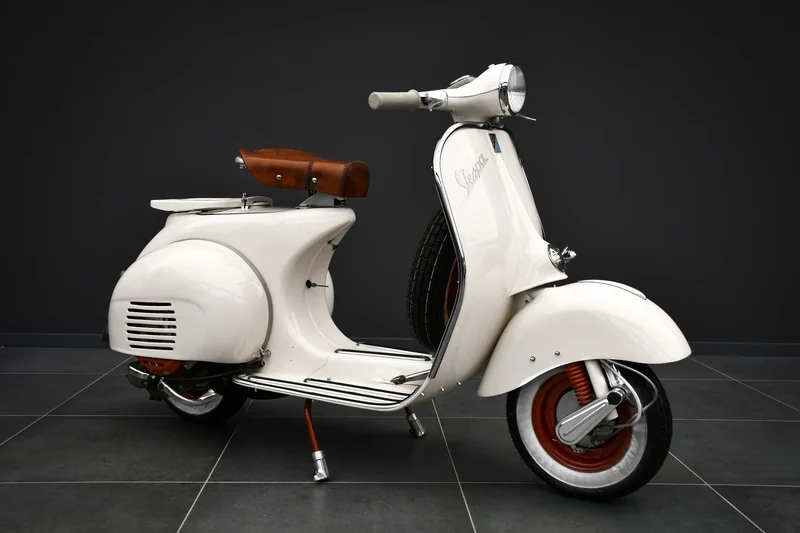 Cream 1957 Vespa side view in the Batman Garage