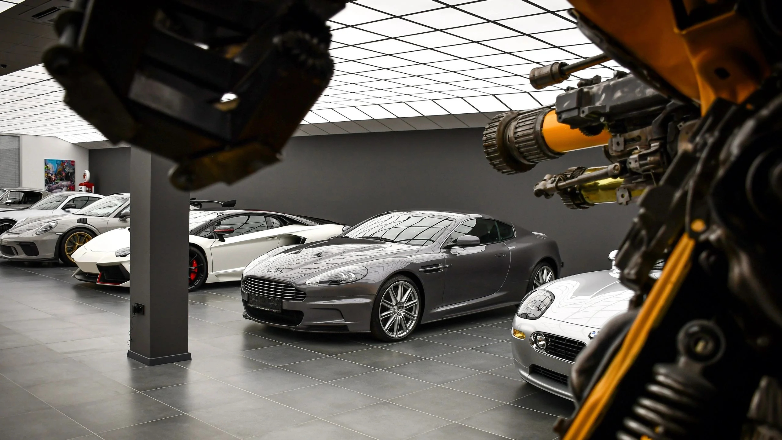 Aston Martin DBS Casino Royale, Lamborghini Aventador SVJ and Porsche 911 GT3 RS in Batman Garage