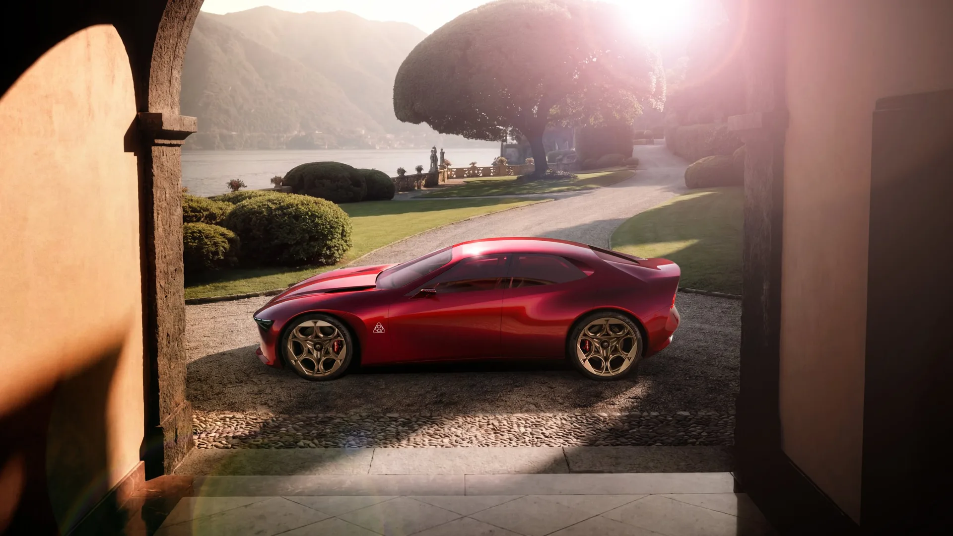Red Alfa Romeo Cuorerosso concept in side profile on a villa driveway by an Italian lake