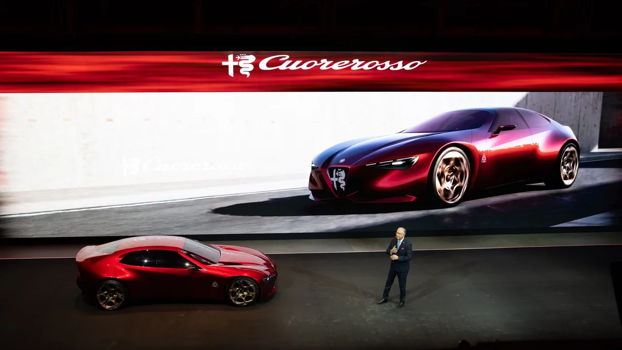 Alfa Romeo Cuorerosso on stage at its reveal, with the Cuorerosso logo and car rendering on the screen behind