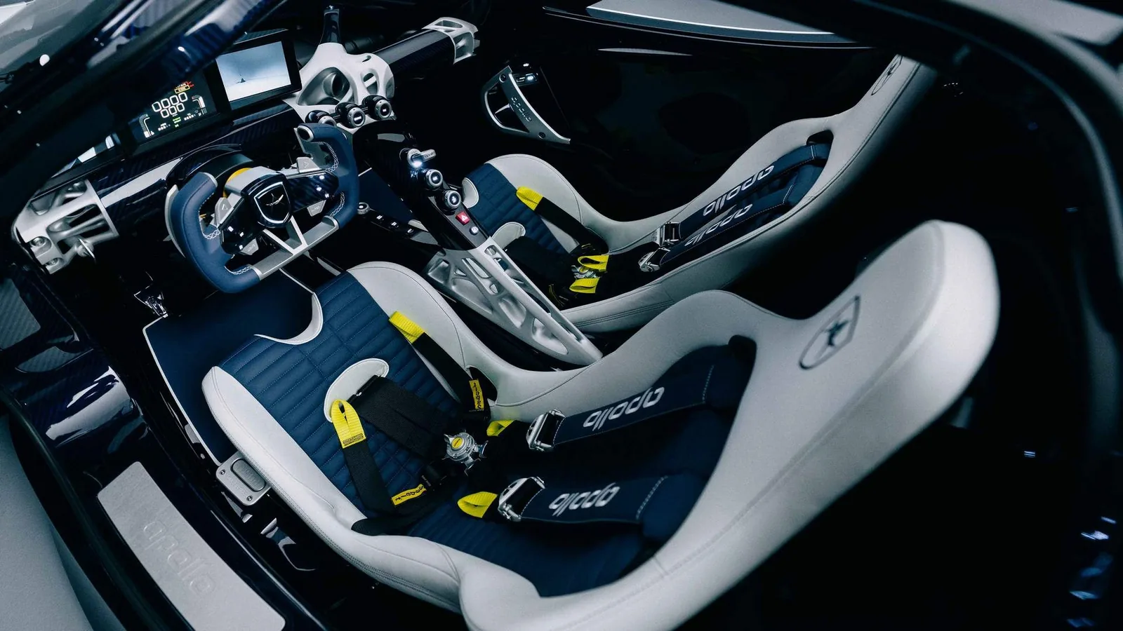 Apollo EVO Caribbean Dragon interior — blue-tinted exposed carbon fibre monocoque tub, 3D-printed aluminium components, white and Ocean Blue leather bucket seats