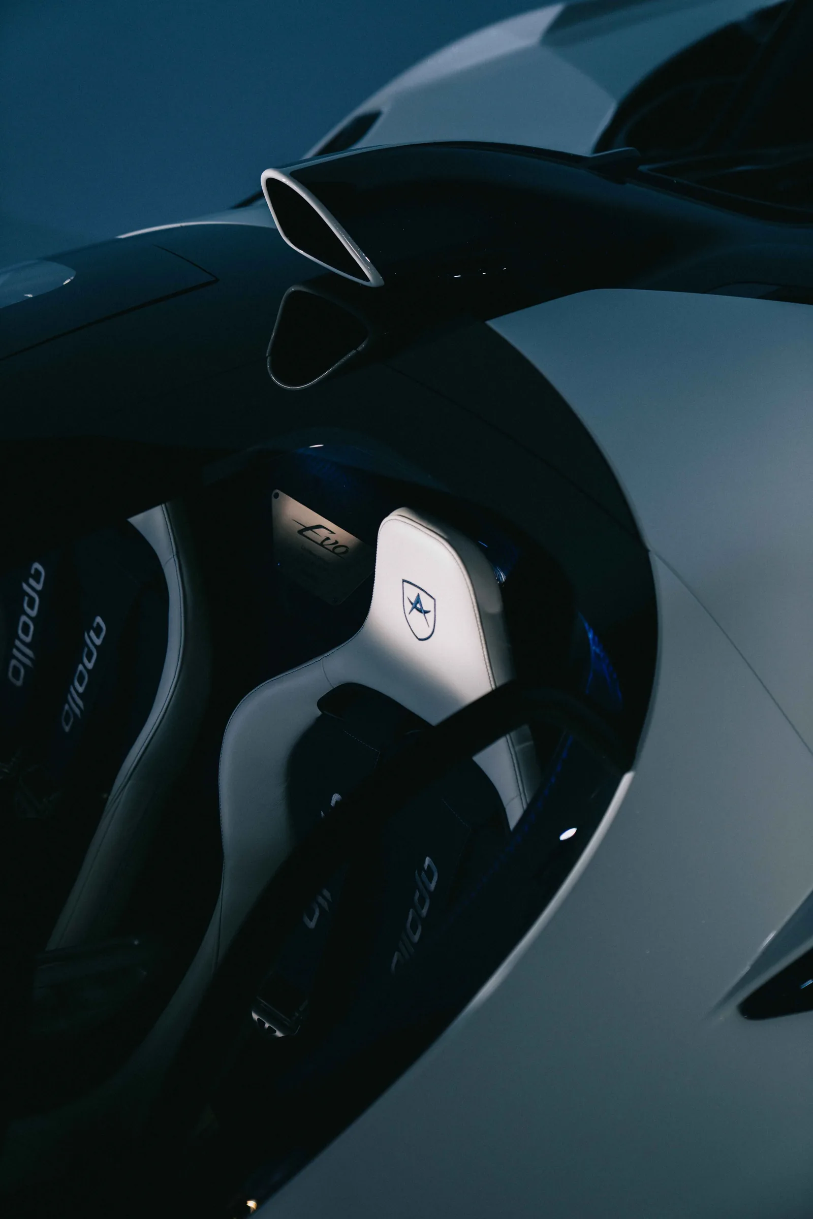 Apollo EVO Caribbean Dragon rear three-quarter — large swan-neck rear wing, twin titanium exhaust tips, Ocean Blue forged rear wheels and diffuser tunnels in the carbon underbody