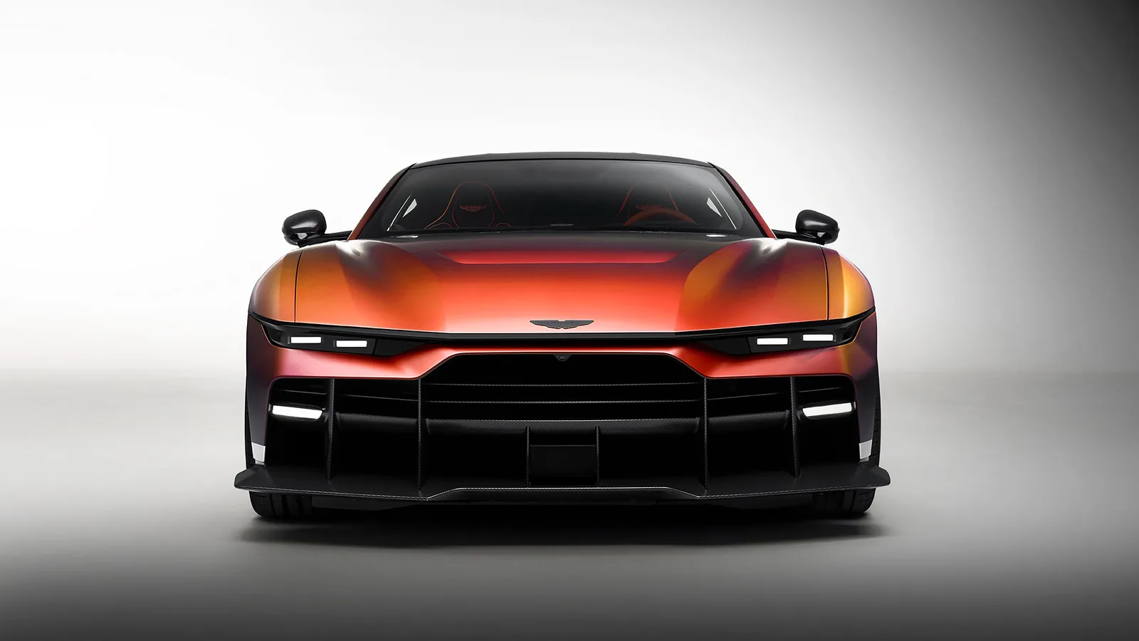 Aston Martin Valen front head-on view with Satin Andromeda Red color-shifting paint, split lighting and full carbon front splitter