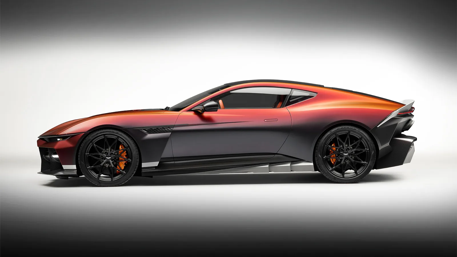 Aston Martin Valen side profile studio shot with Satin Andromeda Red paint, black carbon side skirts and 21-inch magnesium wheels