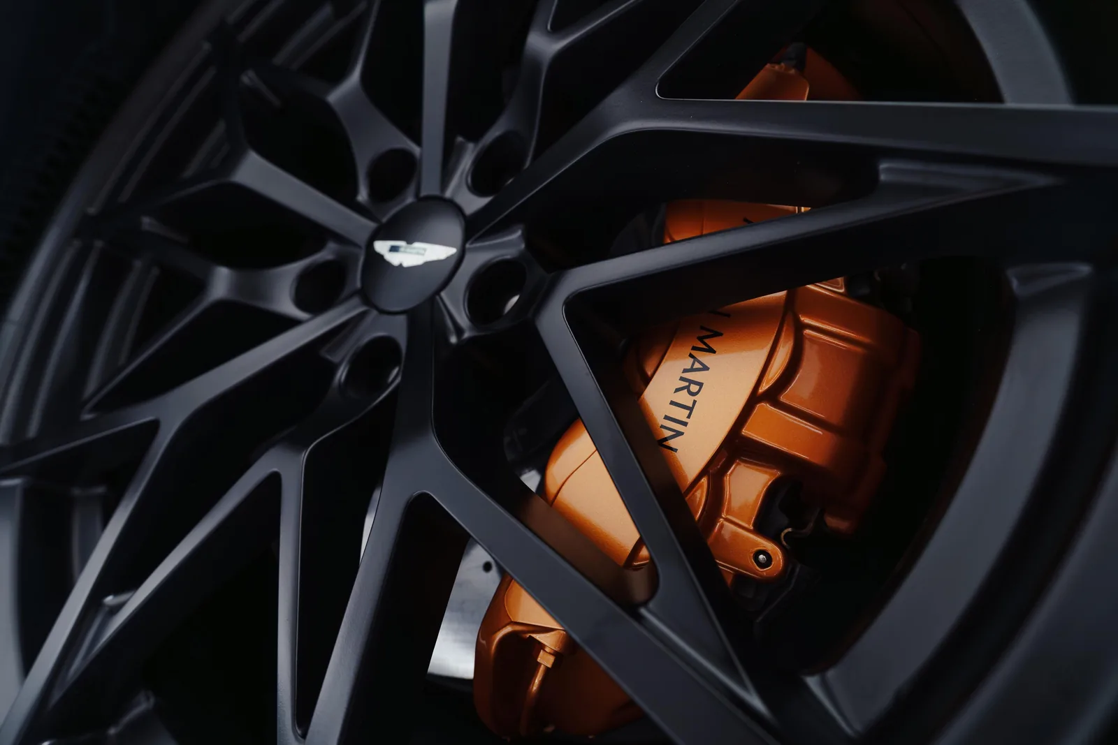 Aston Martin Valen wheel close-up with bronze brake caliper and Aston Martin script on carbon ceramic disc