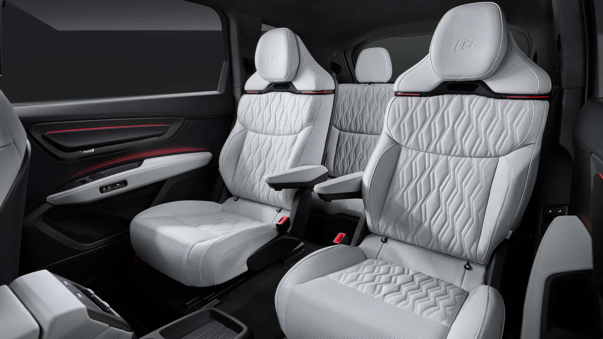 Audi SQ9 second-row seats with embossed S logo on headrests — grey quilted leather, red ambient light strip on door panels