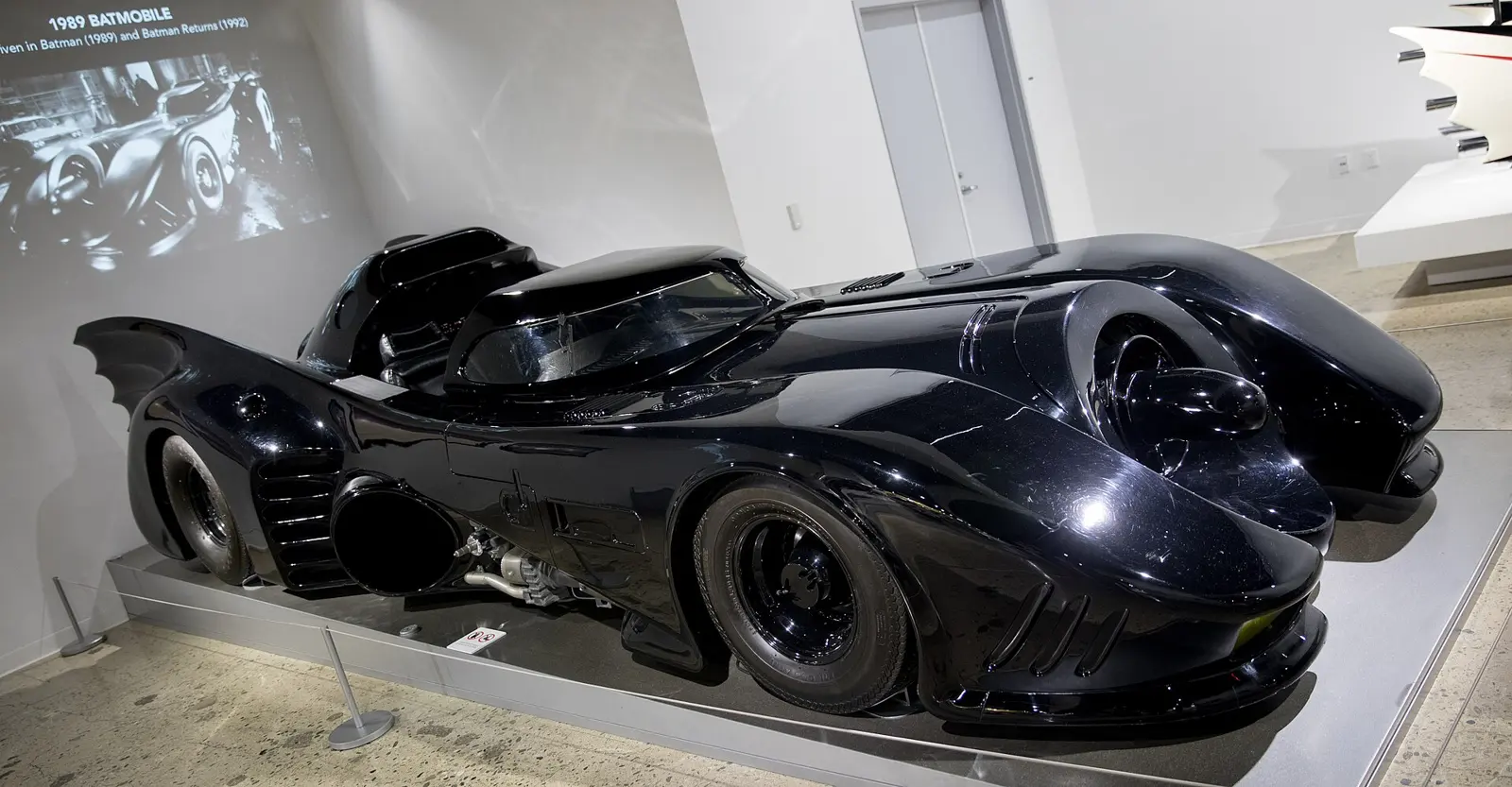 Side profile of the 1989 Tim Burton Batmobile showing its long fibreglass body, low canopy and bat-wing tail fins
