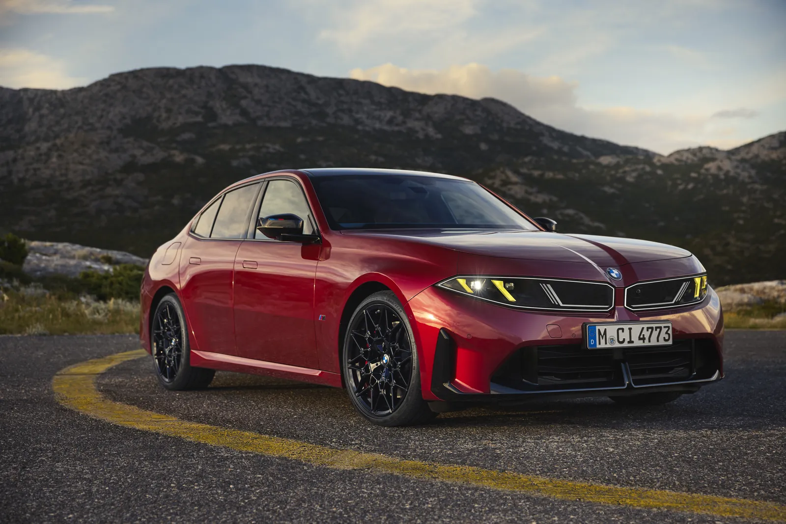 Red BMW M350 xDrive G50 front view with kidney grille merged into the headlights and yellow lights