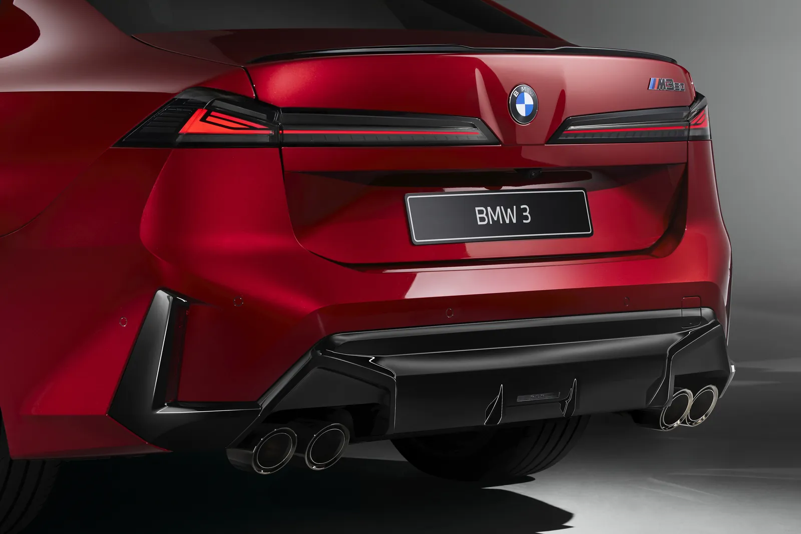 Red BMW M350 xDrive G50 rear with horizontal tail lights and quad tailpipes
