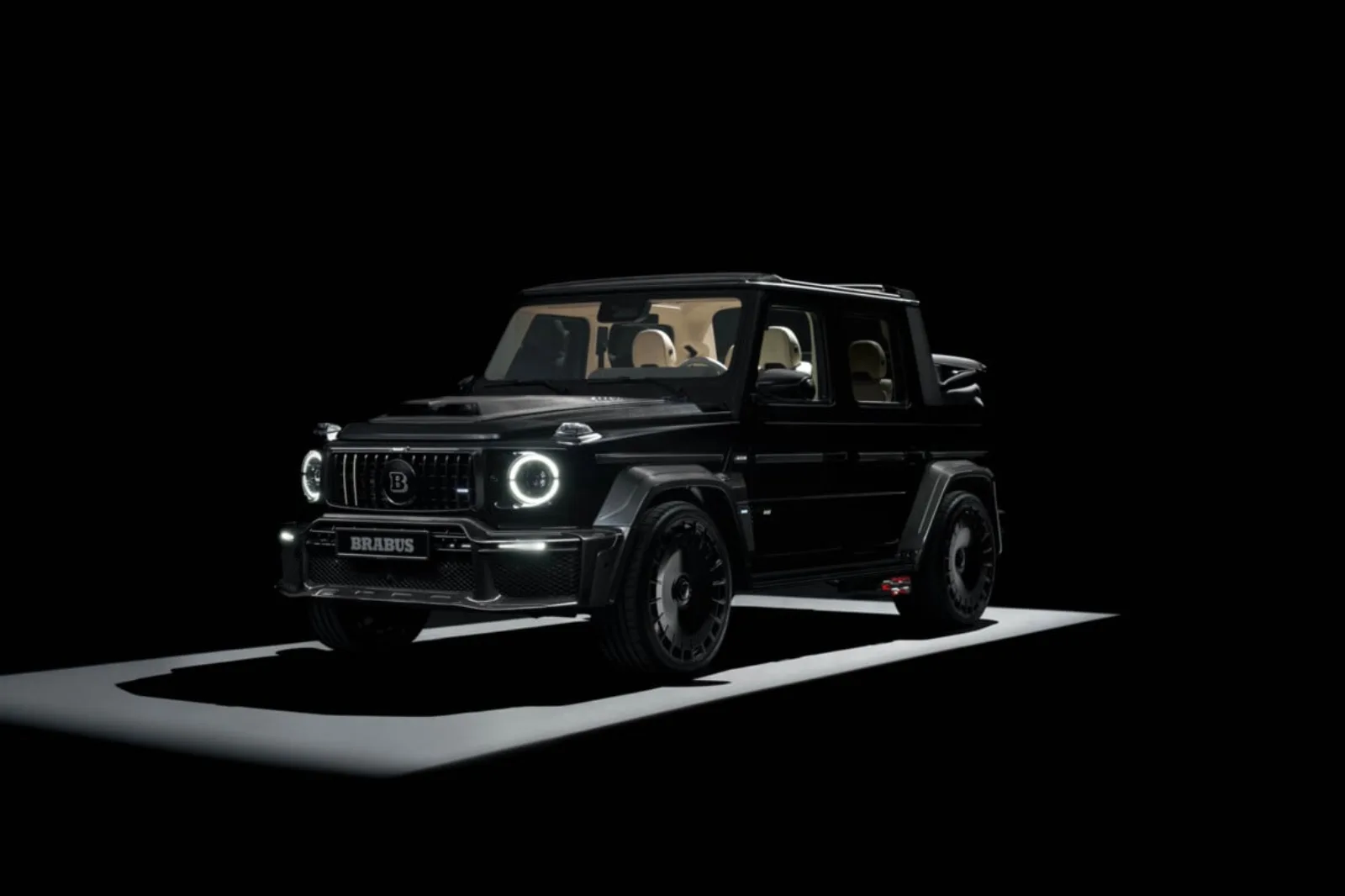 Brabus 800 Cabrio side profile in Metallic Black with soft top raised, showing widebody arches, carbon side skirts and side-exit stainless exhaust with red LED accents