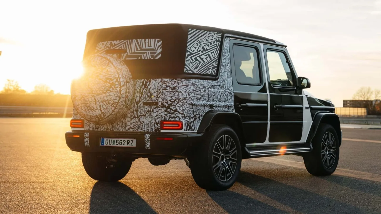Mercedes-AMG G63 Cabriolet camouflaged prototype in profile, revealing 22-inch AMG wheels, side-exit AMG exhaust and long-wheelbase four-door proportions