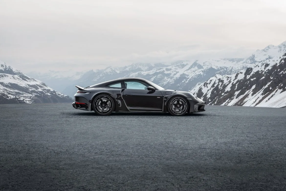 Brabus 900 Rocket R rear three-quarter view showing WIDESTAR rear fascia, carbon diffuser, four Inconel tailpipes and carbon rear spoiler