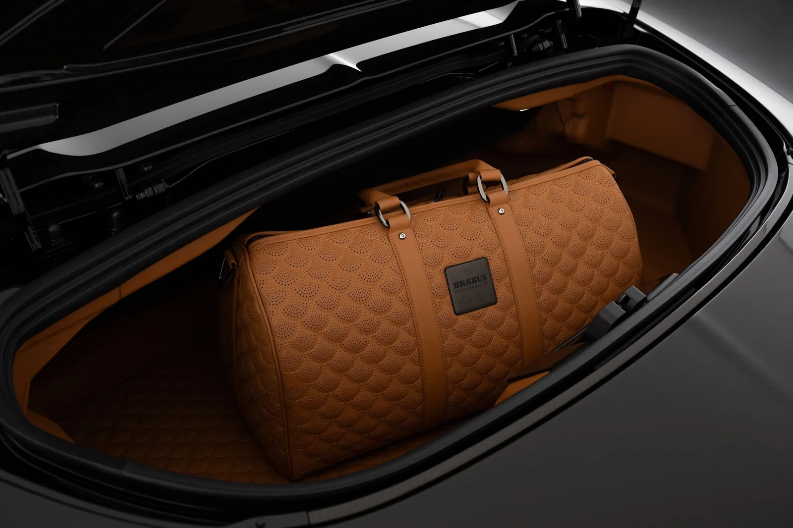 Bespoke Brabus Masterpiece leather duffle bag in matching Saddle Brown leather stowed in the boot of the Bodo Cabriolet