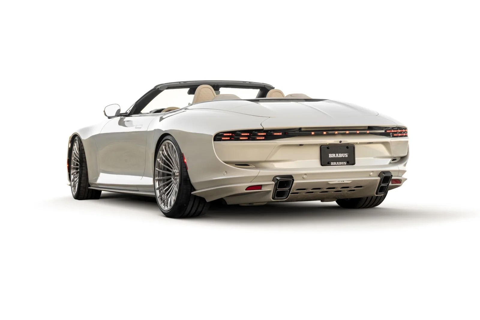Brabus Bodo Cabriolet Silk Stone rear three-quarter with roof down showing carbon spoiler retracted and BRABUS lightbar