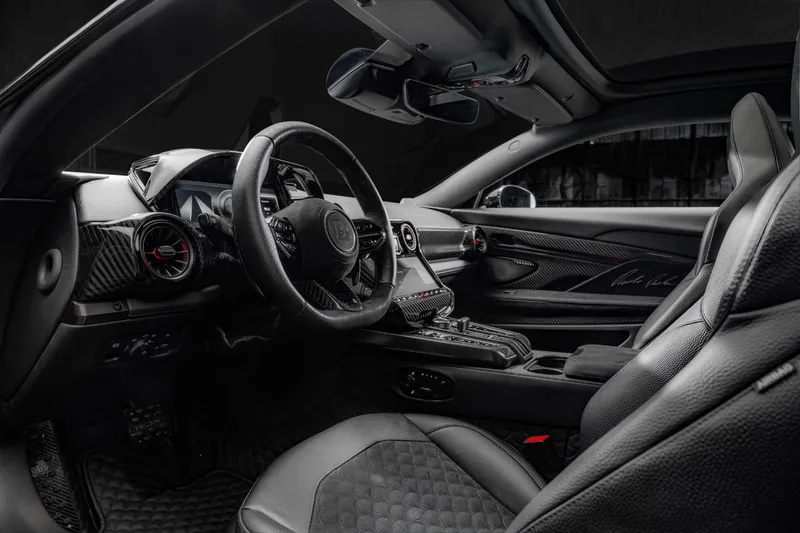 Brabus Bodo interior with flat-bottom steering wheel, carbon-fiber center console, black leather and Nubuck quilted seats with embroidered BRABUS BODO silhouette