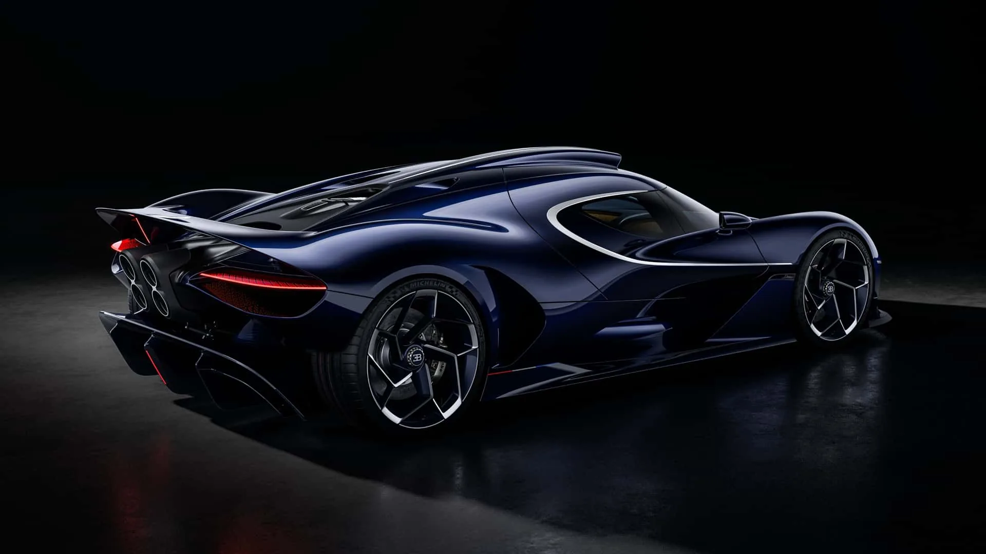 Bugatti Destrier rear three-quarter studio close-up &mdash; 21-inch rear wheel, tinted-carbon rear deck and Sapphire Celeste paint