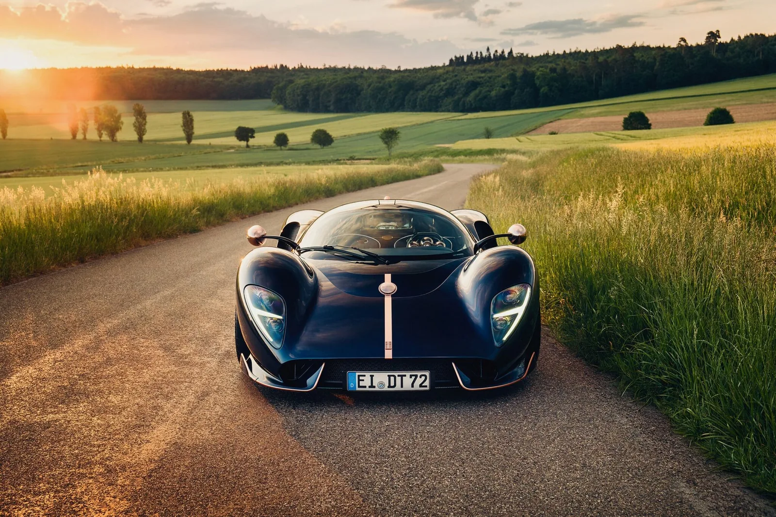 De Tomaso P72 Aurelian Night head-on front view showing rose gold splitter, intakes and centre stripe at sunset