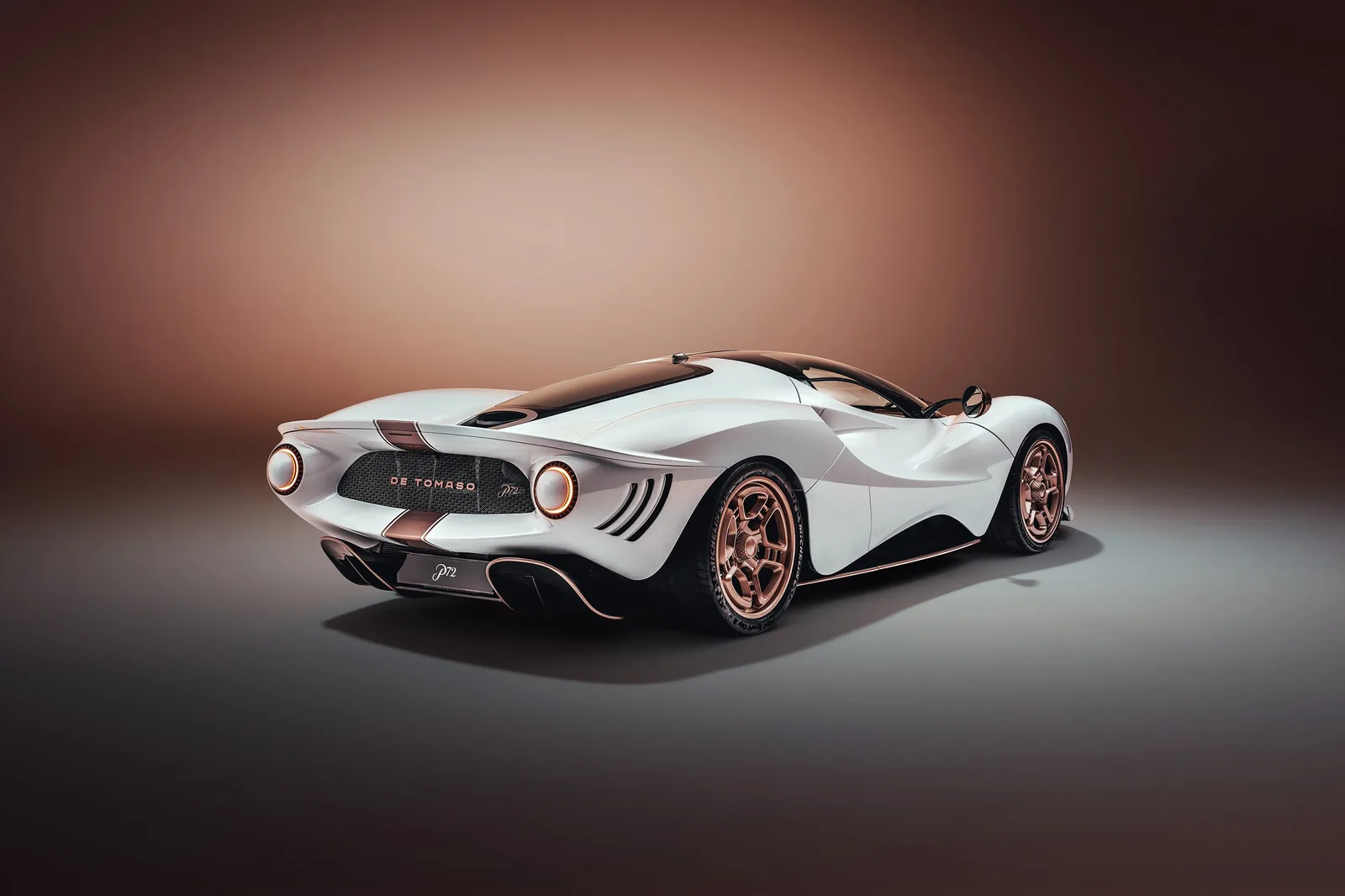 De Tomaso P72 rear three-quarter showing top-exit exhausts and copper wheels