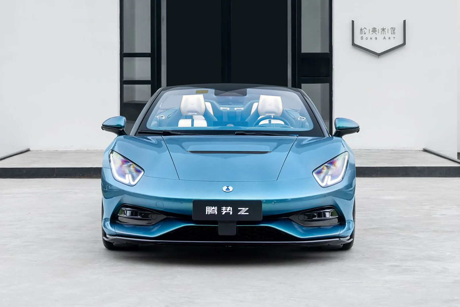 Denza Z Convertible head-on front view showing four-seat cabin, illuminated daytime running lights and Firenze green nose