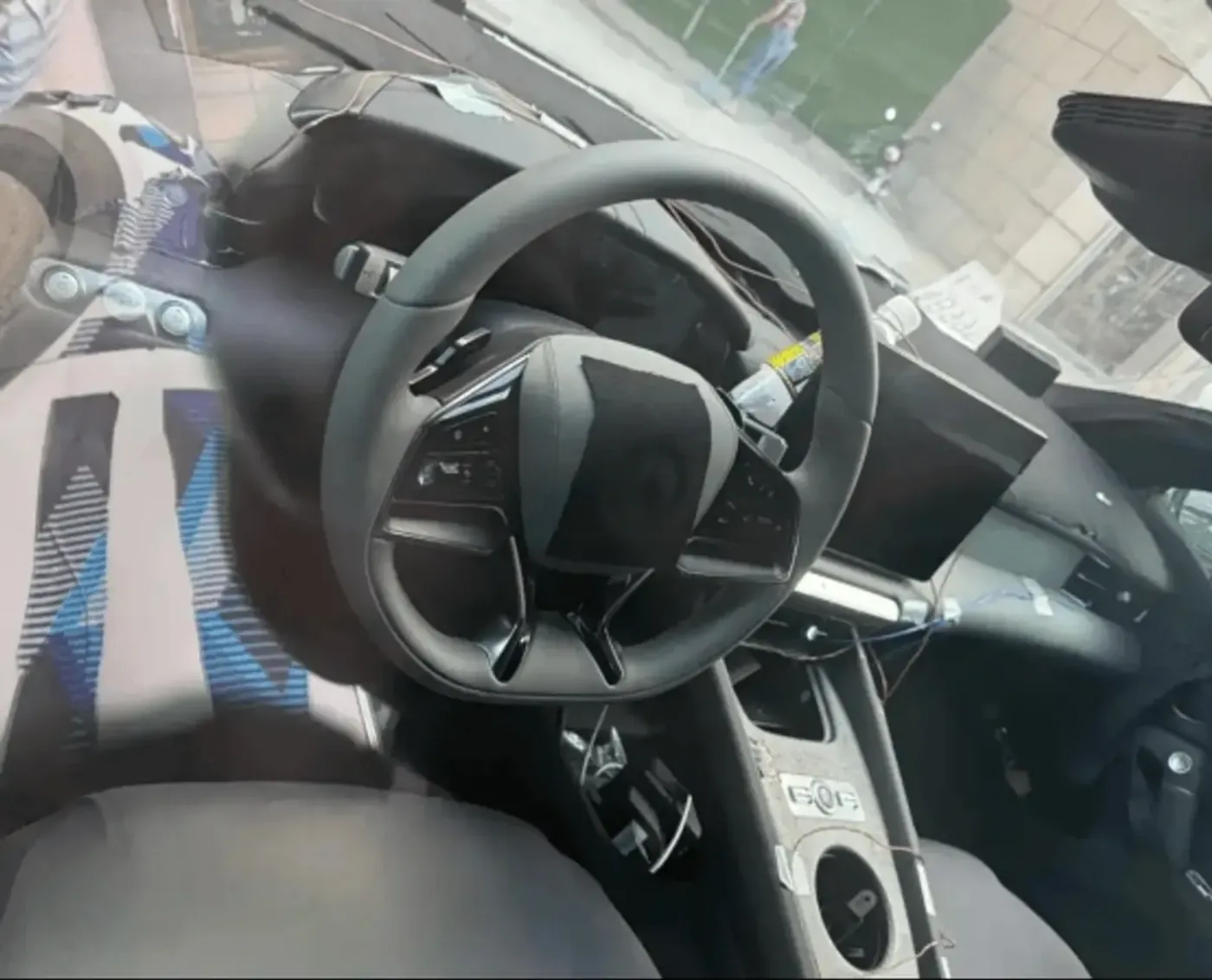Denza Z Convertible cockpit close-up showing the steering wheel, capacitive switchgear and central touchscreen of the production interior