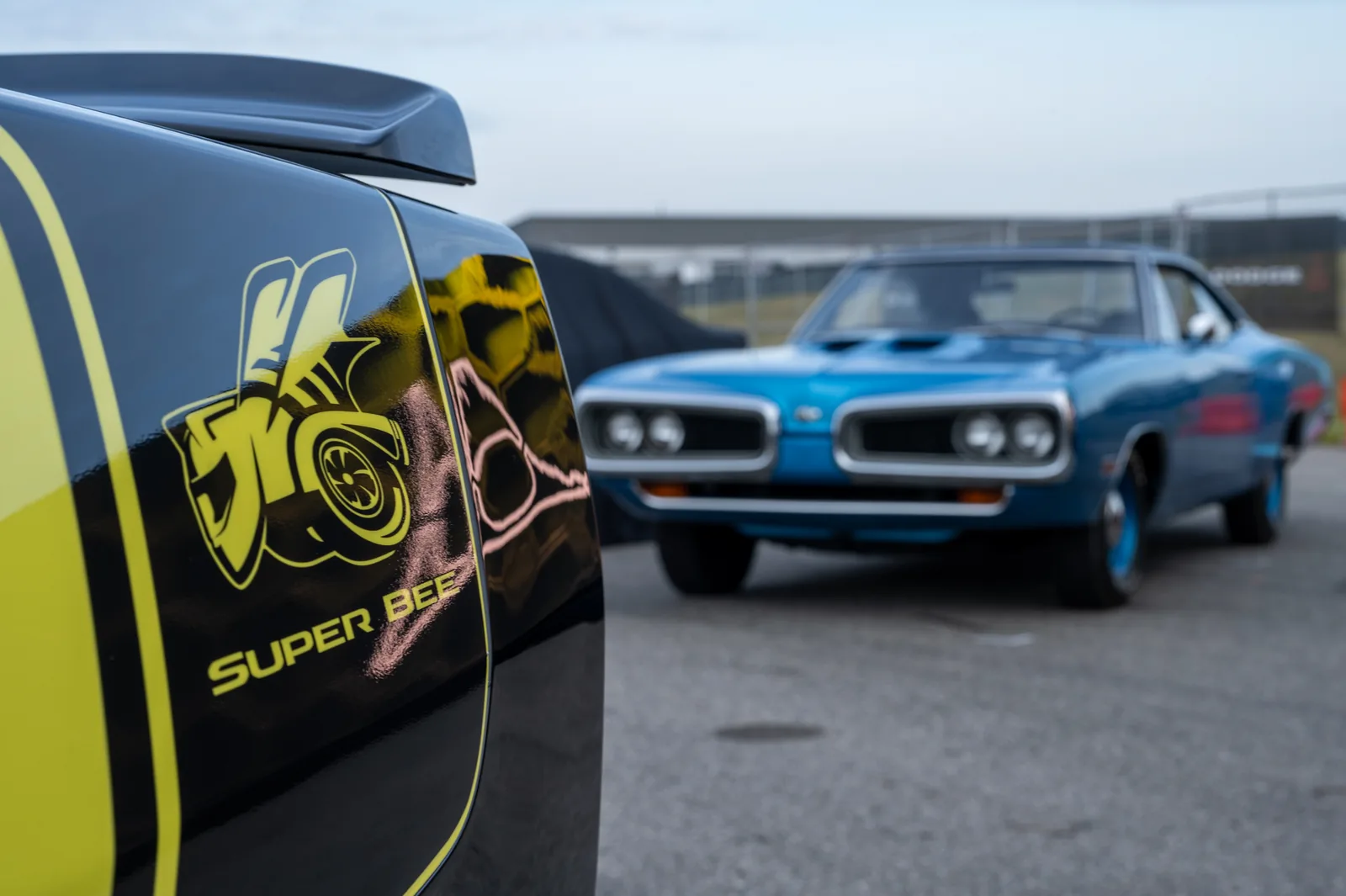Dodge Charger Super Bee bodyside badge close-up &mdash; new turbo-spool inspired Super Bee logo on gloss-black graphics