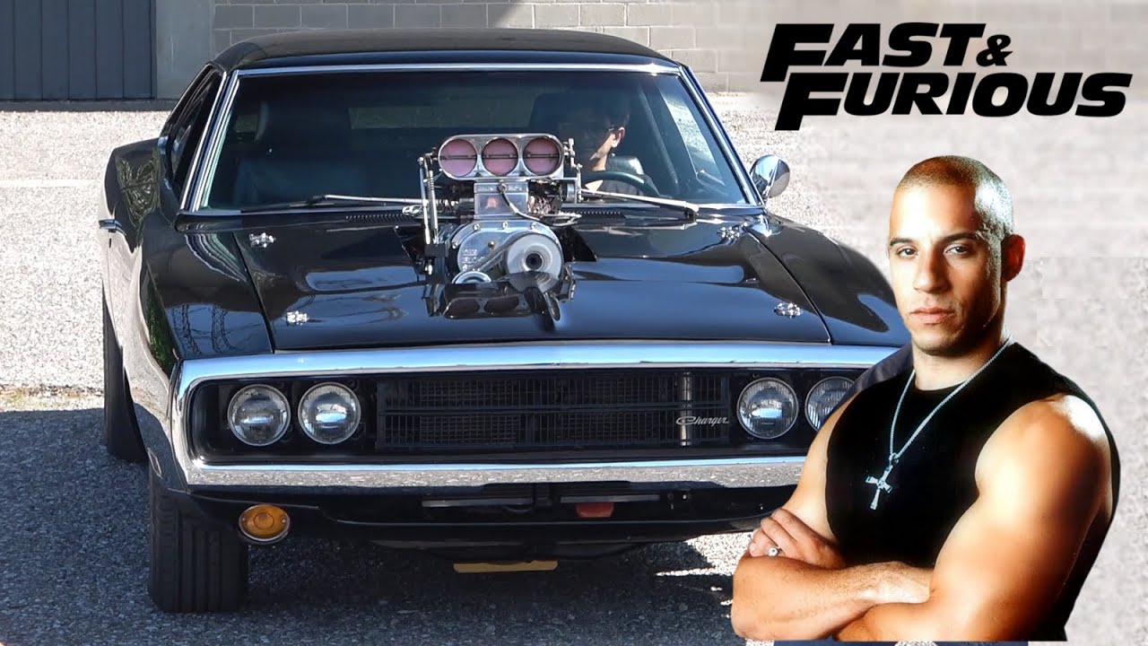 Front view of a black supercharged Dodge Charger with a Vin Diesel and Fast and Furious graphic