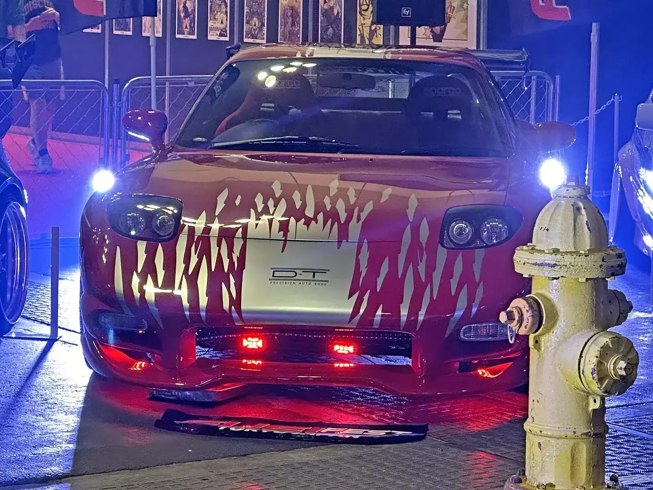 Red Mazda RX-7 FD with black graphics styled as Dom Toretto’s car from The Fast and the Furious