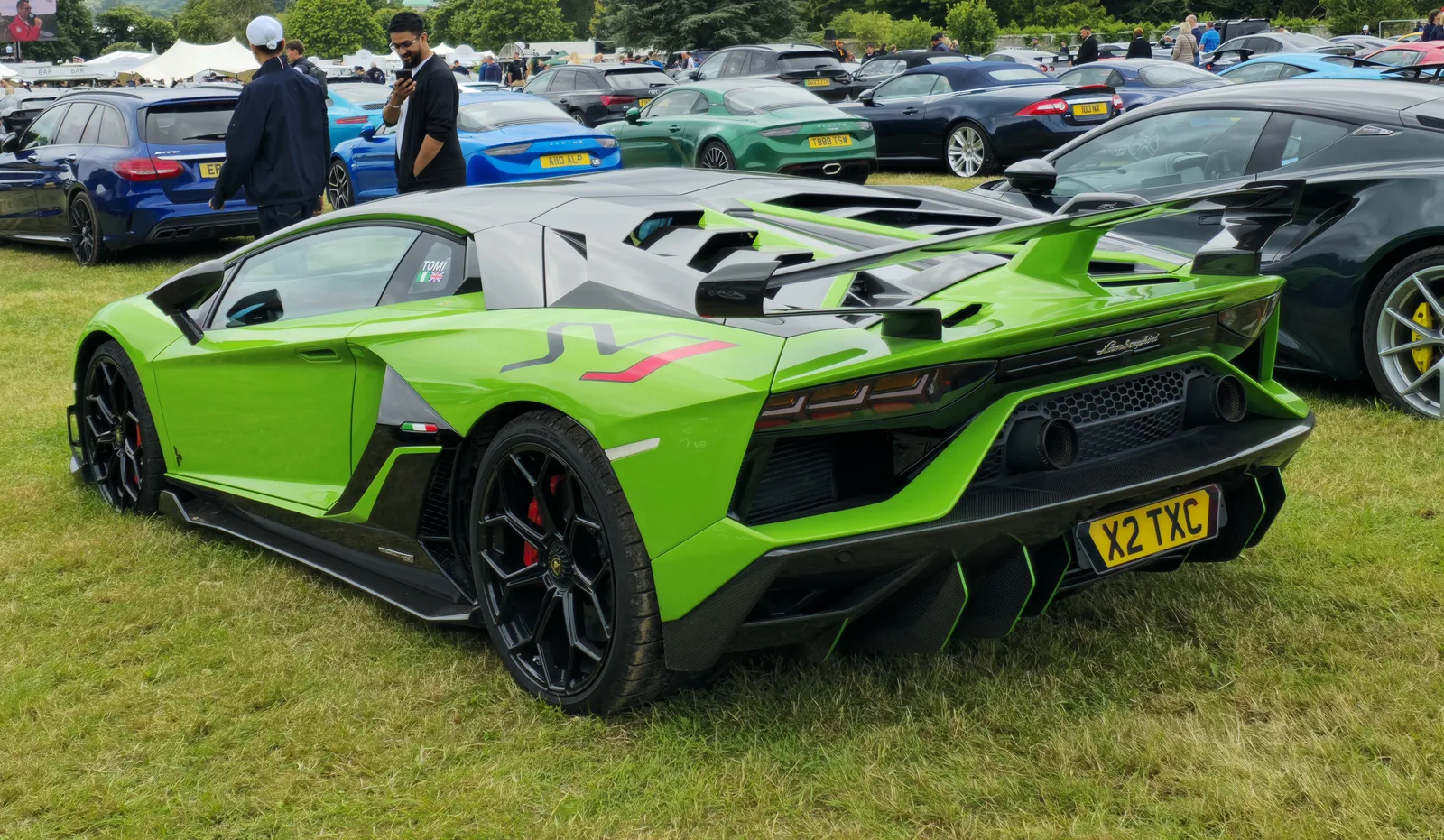 Lamborghini Aventador SVJ in green, rear three-quarter view showing the full-width diffuser, hexagonal tail lights and centrally mounted twin exhaust outlets
