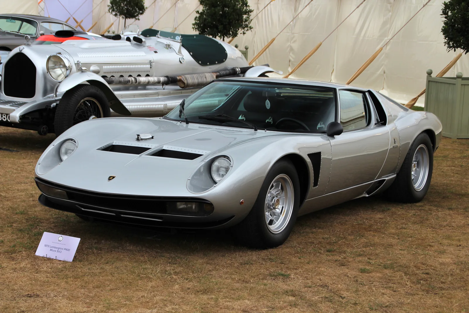 Lamborghini Miura P400 SVJ in silver, front three-quarter view showing the Jota-style front spoiler, brake cooling ducts and fixed covered headlamps of the factory SVJ conversion