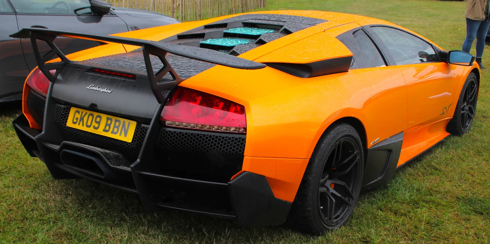 Lamborghini Murcielago LP670-4 SuperVeloce in orange, rear view showing the high-mounted Aeropack wing, hexagonal engine cover vents and central exhaust of the first all-wheel-drive Super Veloce